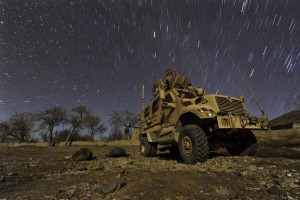 U.S. Army Pfc. Brent Dawkins, left, and U.S. Air Force Tech. Sgt. Efren Lopez sleep on the ground outside a mine-resistant, ambush-protected vehicle during a cold winter night in Wam Valley, Kandahar province, Afghanistan, Dec. 22, 2009. (U.S. Air Force photo by Tech. Sgt. Efren Lopez)